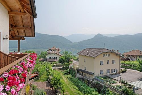 a view of a town with flowers and mountains at Seaberhof Kaltern in Caldaro