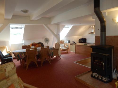 a living room with a table and a fireplace at Luxe Appartement Hertvíkovice in Vlcice