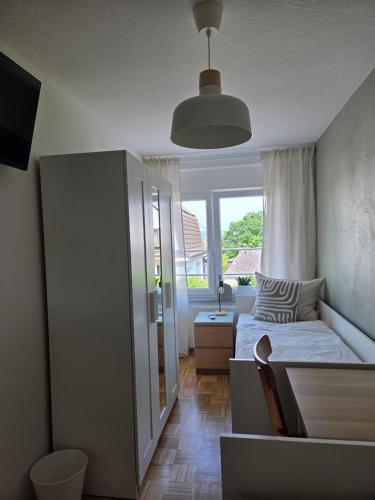 a small bedroom with a bed and a window at TKS HOME Kroppacher Schweiz in Müschenbach
