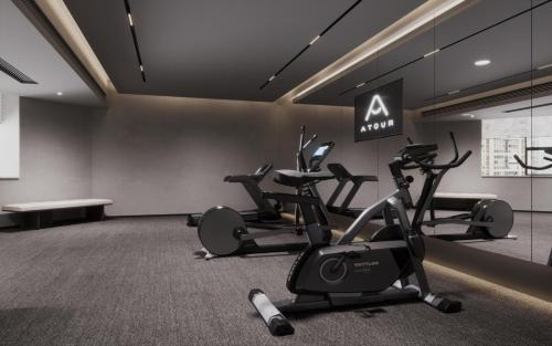 a gym with three exercise bikes in a room at Atour Hotel Chongqing Grand Hall Jialing River Riverside Road in Chongqing