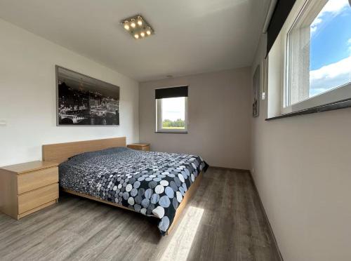 a bedroom with a bed and a large window at Chambre à la campagne 