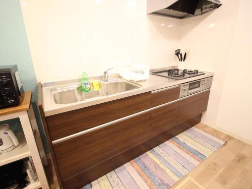 a kitchen with a sink and a stove at Base in Onnason,Okinanawa in Onna