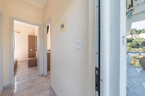 a hallway with a door leading to a room at Alex bar apartments in Sarakiniko