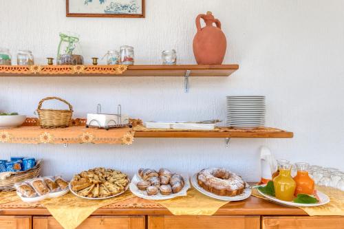 a table with plates of pastries and bread on it at bed and breakfast Tallyho in Salve