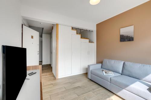 a living room with a couch and a staircase at Viganello Modern Apartments in Lugano