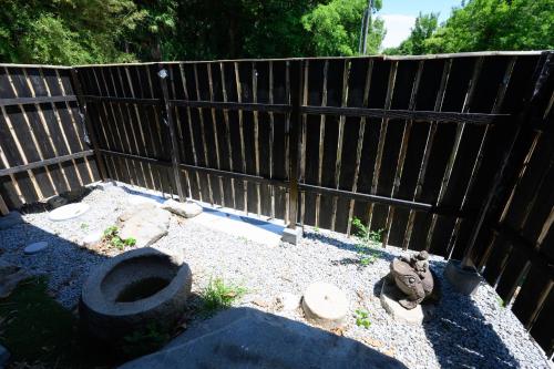 a backyard with a toilet and a wooden fence at Kino in Takamatsu