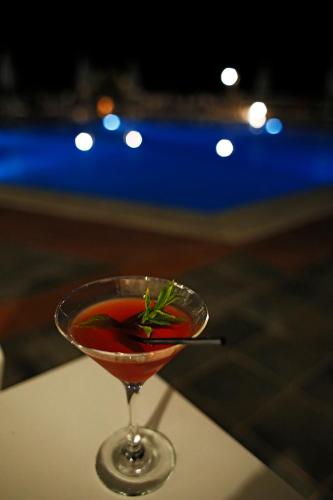 a drink in a martini glass sitting on a table at Asteris Hotel in Skala Kefalonias