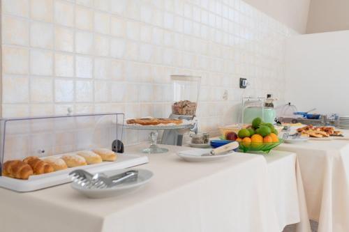 a table with pastries and other food on it at Piccolo Hotel Villa Rosa in Ostuni