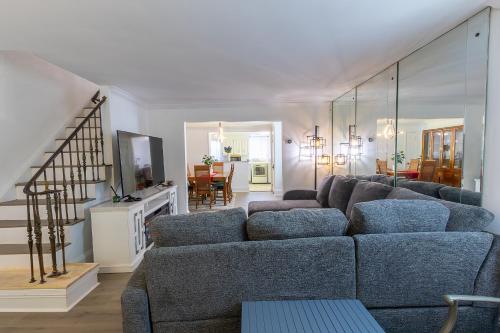 a living room with a couch and a tv at ComfiNook Cozy Suburb Stay Philly Airport Parking