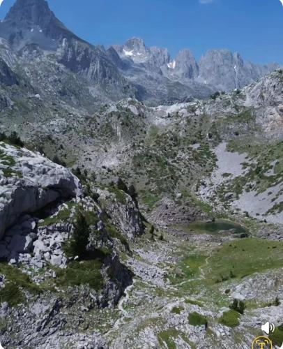 an aerial view of a mountain with mountains in the background at PROKLETIJE eko katun Vusanje in Gusinje
