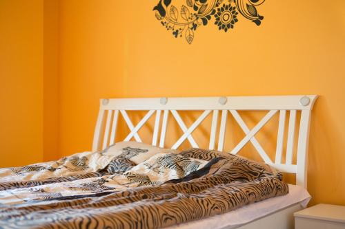 a zebra print bed in a room with yellow walls at Amazing Penthouse old town in Sarajevo