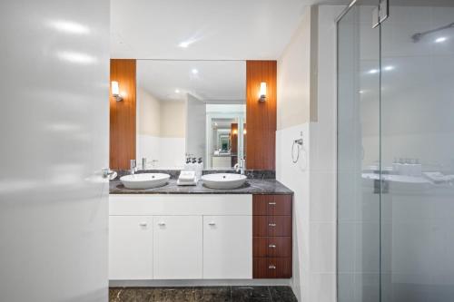 a bathroom with two sinks and a shower at Chevron Renaissance - Private Apartments - Hosted by Coastal Letting Co. in Gold Coast