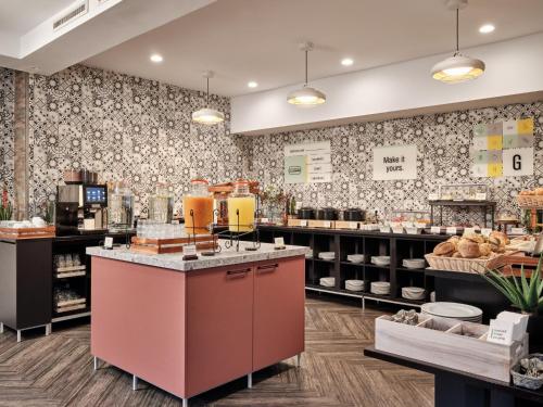 a bakery with a counter in a store at Garner Hotel Berlin - Schöneberg by IHG in Berlin