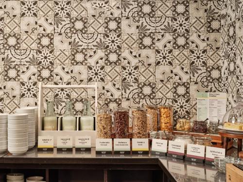 a store display of food items on a shelf in front of a wall at Garner Hotel Berlin - Schöneberg by IHG in Berlin