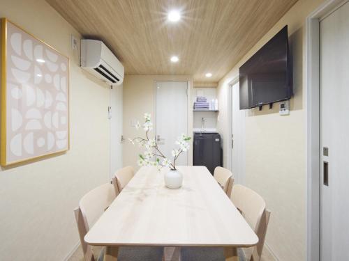 a dining room with a white table and chairs at tokyo Japandi apartment ikebukuro in Tokyo