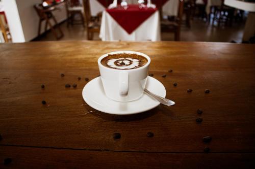 a cup of coffee sitting on top of a table at Sunny Palms Beach Bungalows in Uroa