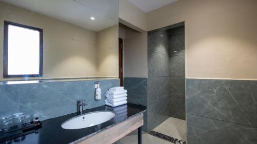 a bathroom with a sink and a shower at Pallacia A Luxury Hotel in Beāwar