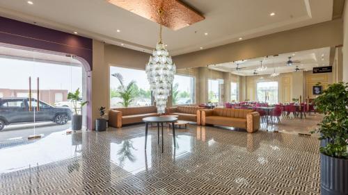 a lobby with couches and a table and chairs at Pallacia A Luxury Hotel in Beāwar