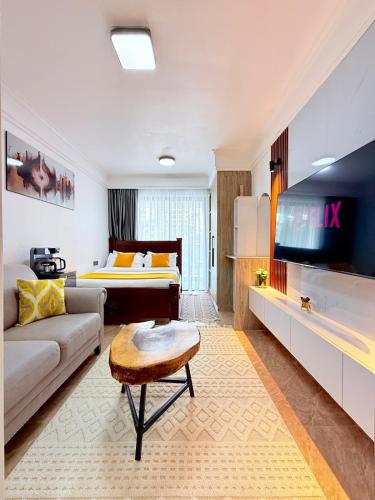 a living room with a couch and a bed at my cozy place in Nairobi
