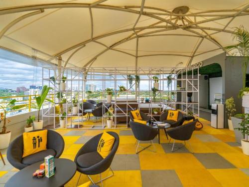 a large room with chairs and tables on a building at The Hosteller Bangalore, Brigade Road in Bengaluru