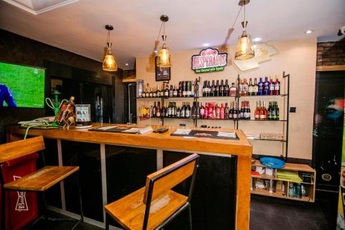 a bar with a wooden counter in a restaurant at Elegance Suites Hotels in Lagos