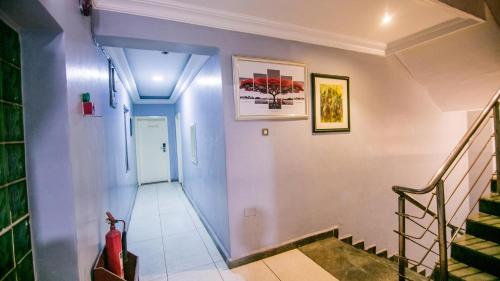 a staircase in a home with blue walls at Elegance Suites Hotels in Lagos