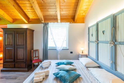 a bedroom with a large bed and a wooden ceiling at HOTELLERIE VALLE SACRA in Cintano
