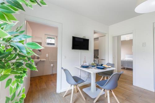 a living room with a white table and chairs at Viganello Modern Apartments in Lugano