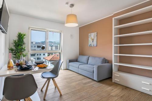 a living room with a table and a couch at Viganello Modern Apartments in Lugano
