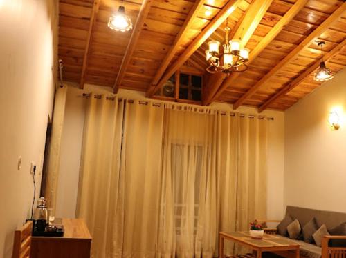 a living room with a curtain and a couch at Panet jungle home stay in Panuānaula