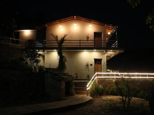 a house with lights on the side of it at night at Panet jungle home stay in Panuānaula