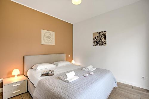 a bedroom with a bed with two towels on it at Viganello Modern Apartments in Lugano