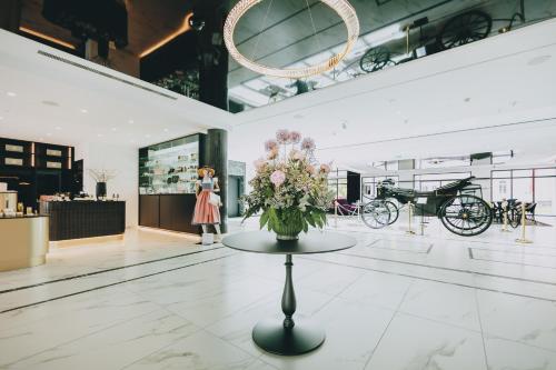 a vase of flowers on a table in a store at Grand Elisabeth in Bad Ischl