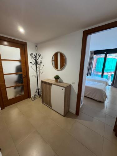 a bedroom with a bed and a mirror on the wall at Piso de SIMBA cerca de playa, con piscina y varias terrazas in Lloret de Mar