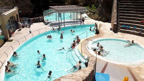 a group of people in a swimming pool at Charmant T2 avec piscine, idéal pour les curistes in Vernet-les-Bains