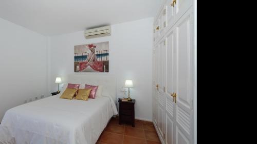 En eller flere senge i et værelse på Apartment Bella View Center Playa Blanca By PVL