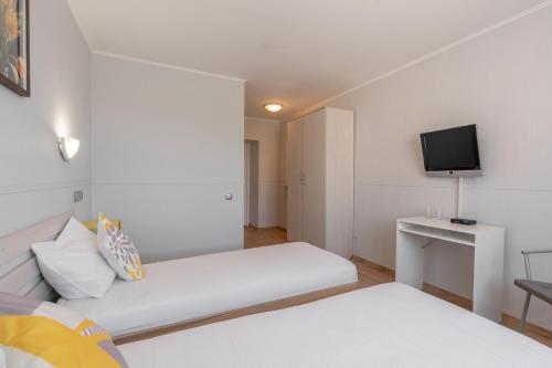 Ένα ή περισσότερα κρεβάτια σε δωμάτιο στο Apart Hotel Tomo FREE PARKING