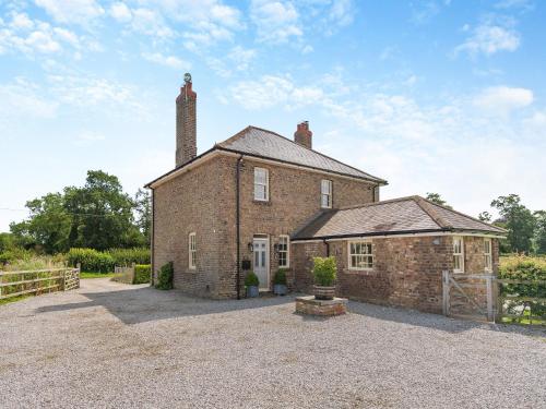 an old brick house with a chimney on top at Farrington House in Lowthorpe