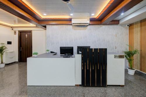 an office cubicle with a white desk with a computer on it at Luxury Studio Apartment with Kitchenette & Private Balcony ,Gurugram in Gurgaon