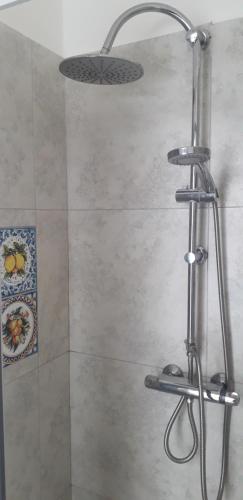 a shower with a shower head in a bathroom at A Casa Di Alex in Catania