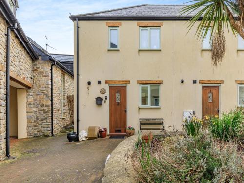 a house with a driveway in front of it at Birch Cottage in Watchet