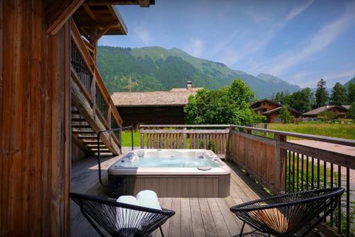 a hot tub on the deck of a cabin at Chalet Plume - OVO Network in Morzine