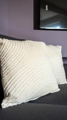 a white pillow sitting on top of a bed at Pinkerton House in Dunfermline