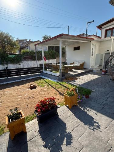 a patio with potted plants and a house at Anastasia's House Νιγρίτα near Serres in Nigríta