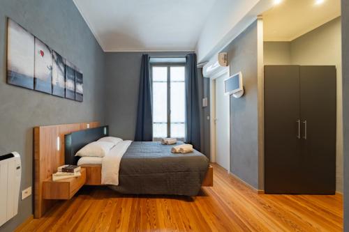 a small bedroom with a bed and a window at Essential Dream in Cuneo