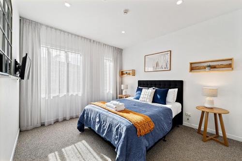 a bedroom with a bed and a television in it at The Waterfront Suites 2 Bedroom in Paihia