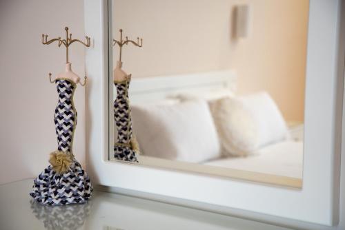 a mirror sitting on a counter next to a bed at Sofia Luxury Apartments in Lechaio