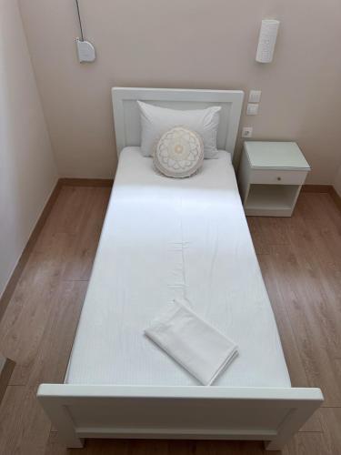 a large white bed in a small room at Sofia Luxury Apartments in Lechaio
