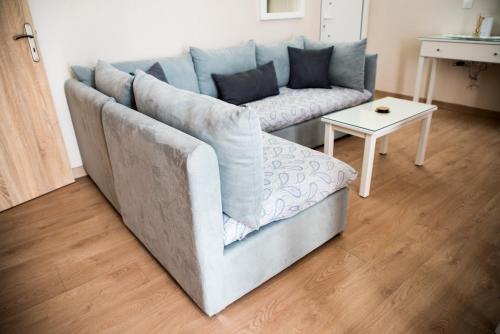 a living room with a couch and a table at Sofia Luxury Apartments in Lechaio