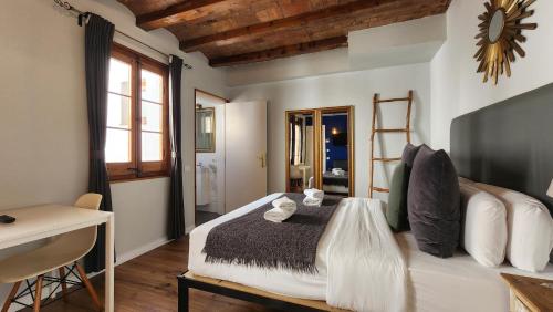 a bedroom with a large bed in a room at Barrio Gotico Apartments Ferran in Barcelona